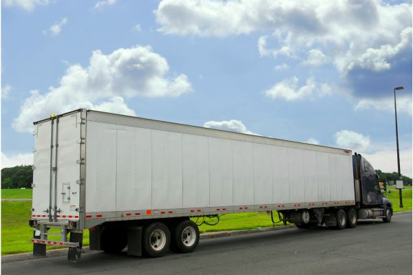 Eighteen Wheeler Truck Parking on Asphalt Driveway