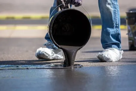 close up of asphalt driveway sealing